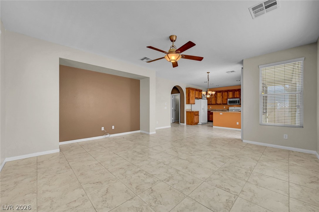 977 Sparkling Light Street Henderson, NV 89052 - Photo 25 of 75 This expansive living space features an open concept layout, connecting to a functional kitchen.