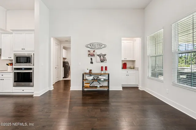 a kitchen with stainless steel appliances granite countertop a sink refrigerator and cabinets
