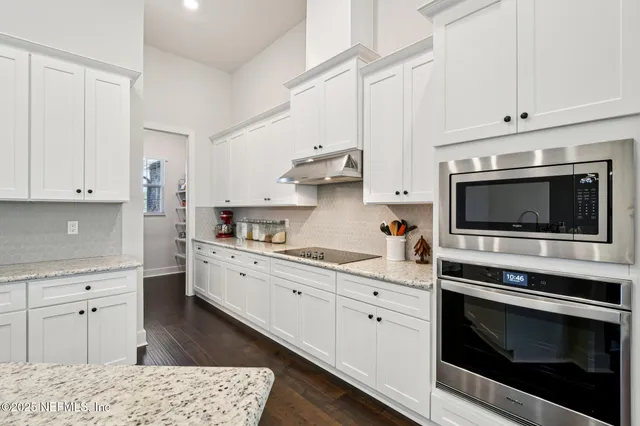 a bathroom with a granite countertop sink mirror and