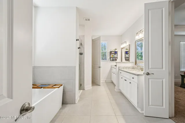 a bedroom with a bed and a tv on the dresser