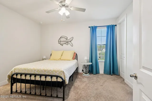 a view of a house with a big yard and large trees