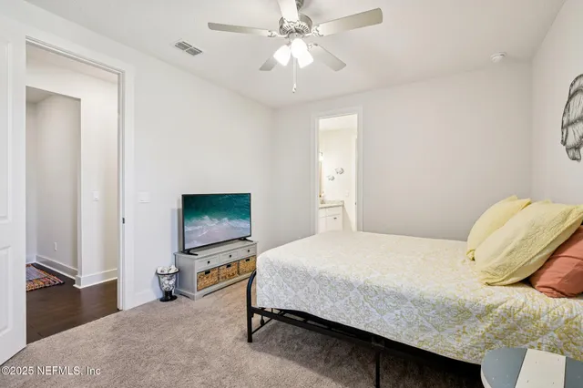 an aerial view of a house with swimming pool and large trees