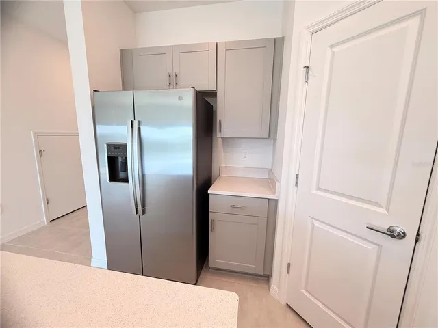 a kitchen with metallic refrigerator freezer and a dishwasher