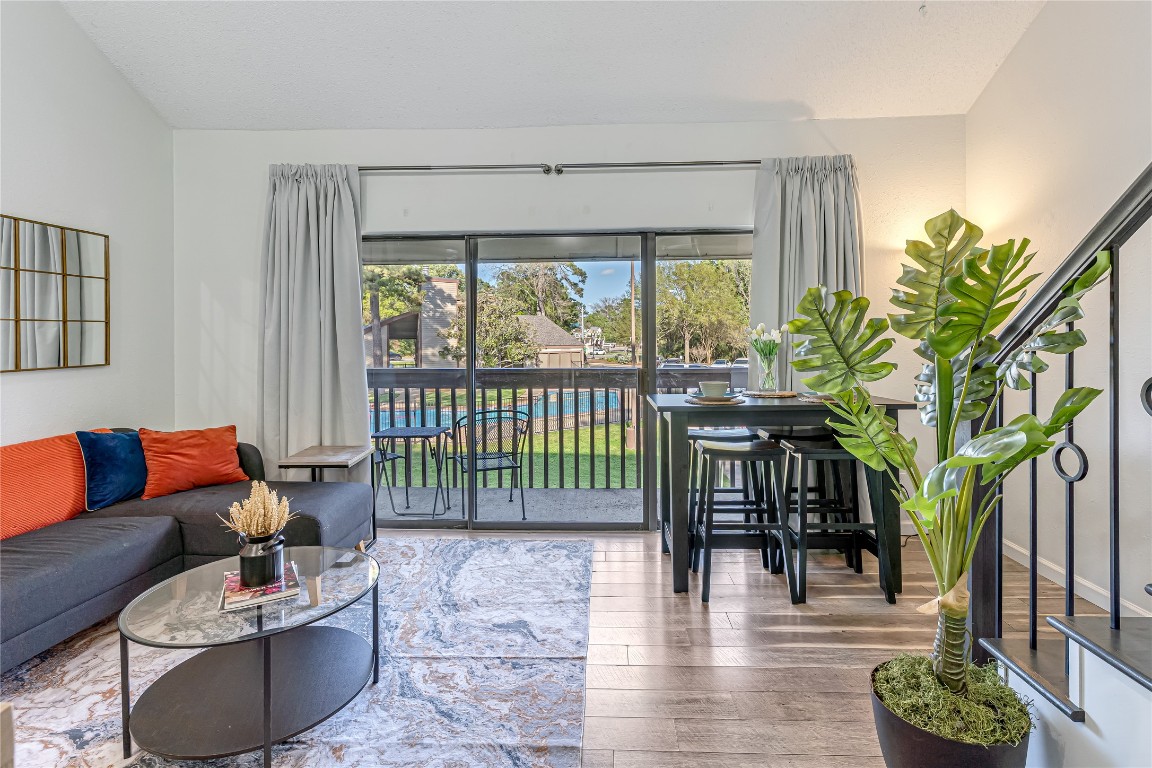 12900 Walden Road, Unit 502E Montgomery, TX 77356 - Photo 1 of 31 a living room with furniture and a large window with outer view
