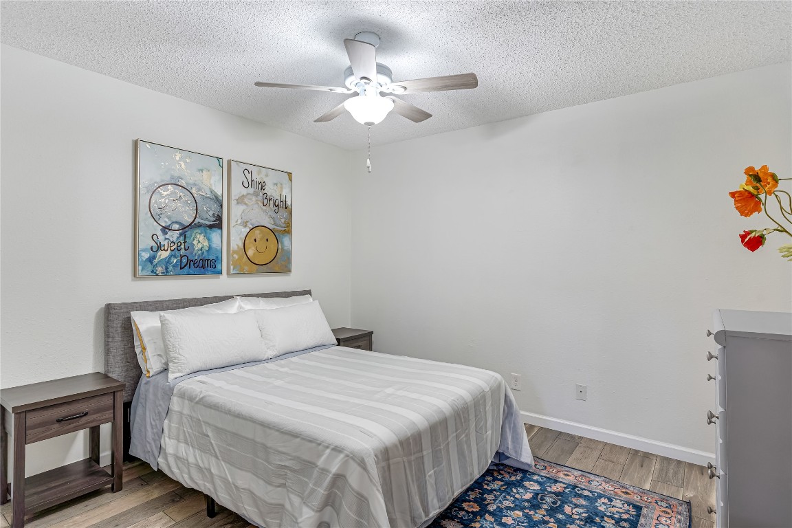 12900 Walden Road, Unit 502E Montgomery, TX 77356 - Photo 15 of 31 a bedroom with a bed and painting on the wall