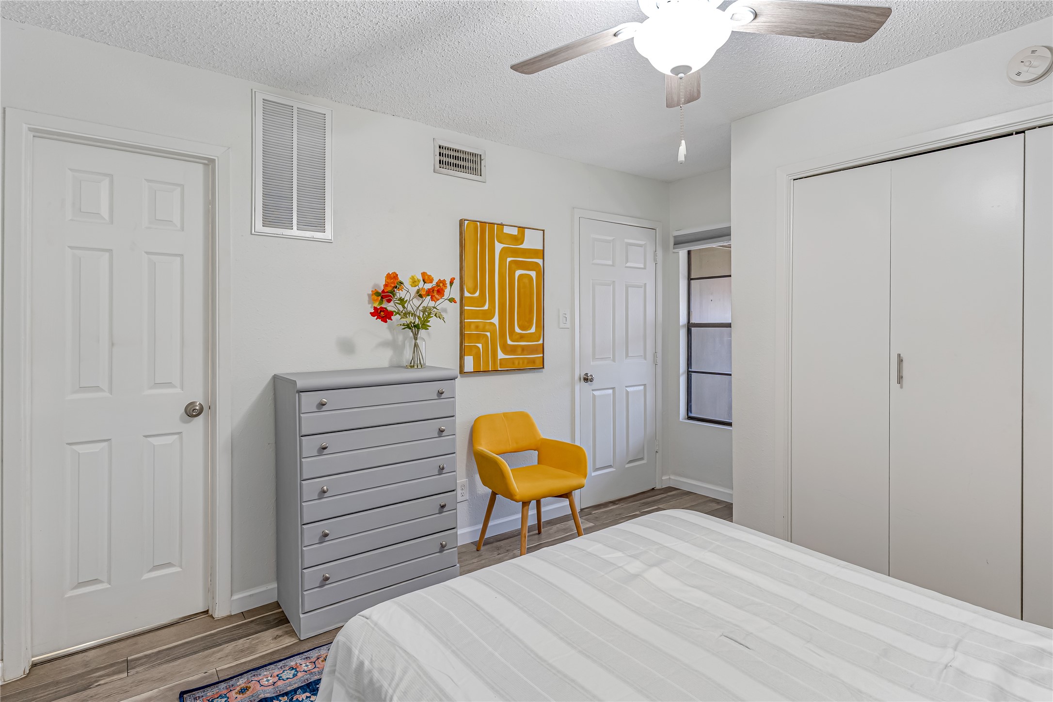 12900 Walden Road, Unit 502E Montgomery, TX 77356 - Photo 16 of 31 a bedroom with a bed and a chandelier