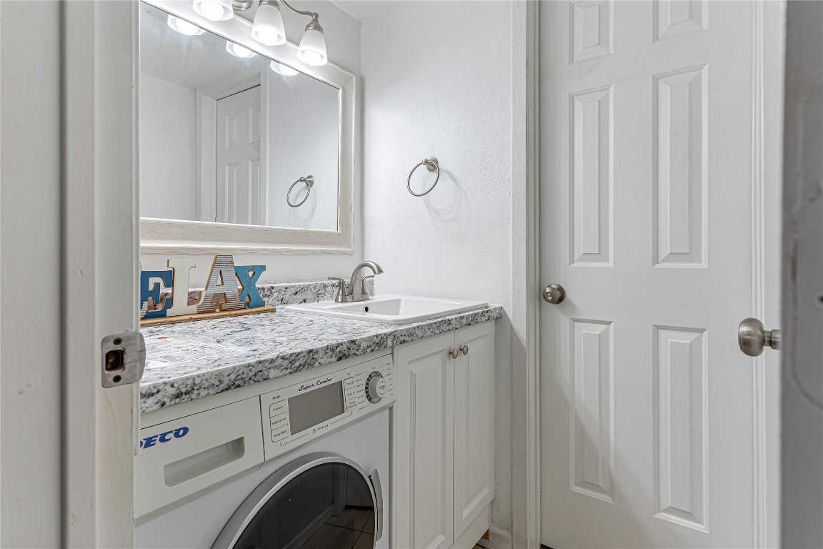 12900 Walden Road, Unit 502E Montgomery, TX 77356 - Photo 18 of 31 a bathroom with a granite countertop sink and a mirror