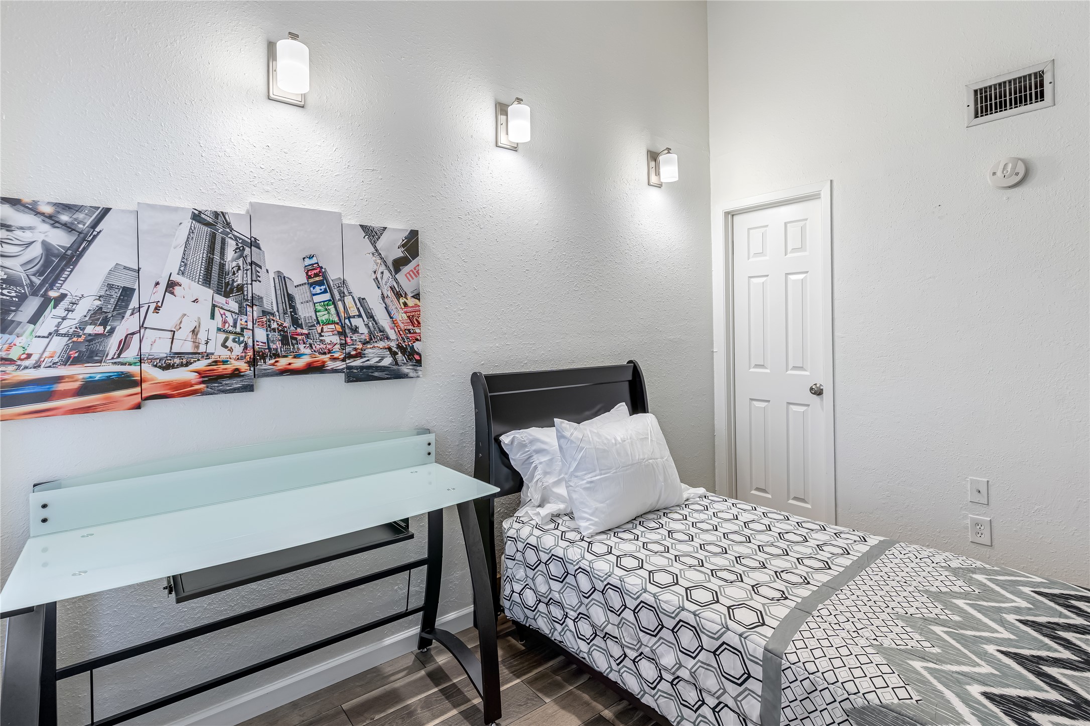 12900 Walden Road, Unit 502E Montgomery, TX 77356 - Photo 19 of 31 a bedroom with a bed and painting on the wall