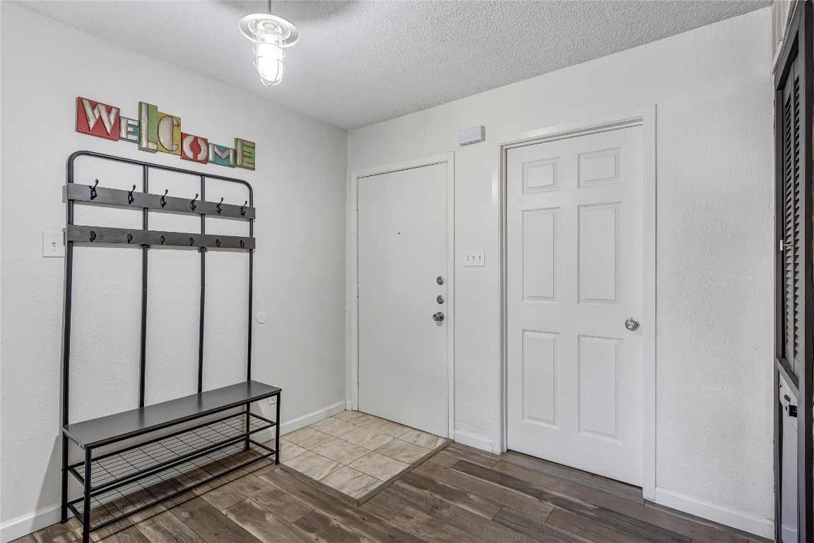 12900 Walden Road, Unit 502E Montgomery, TX 77356 - Photo 2 of 31 a view of a hallway with wooden floor and closet