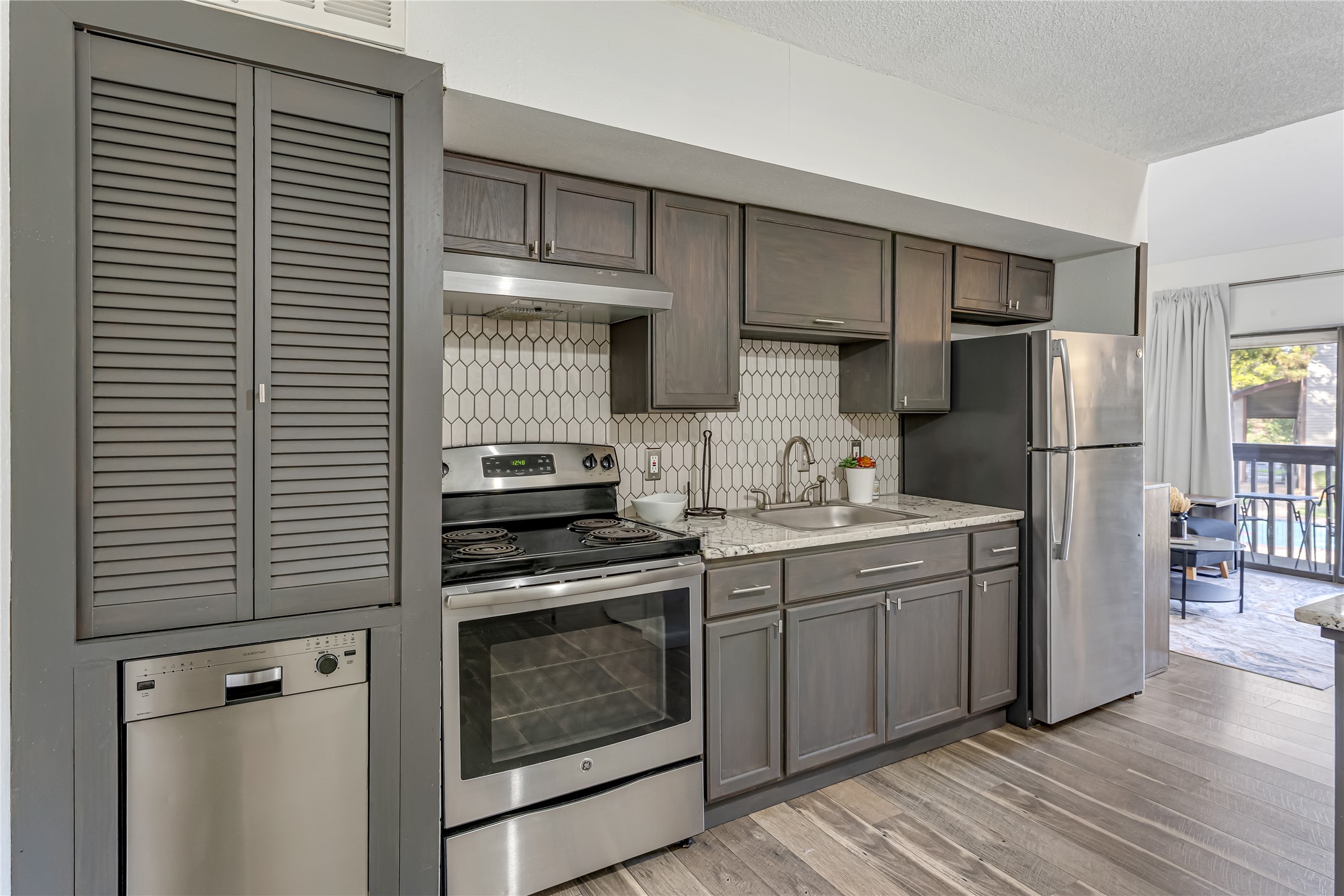 12900 Walden Road, Unit 502E Montgomery, TX 77356 - Photo 4 of 31 a kitchen with a sink cabinets and stainless steel appliances