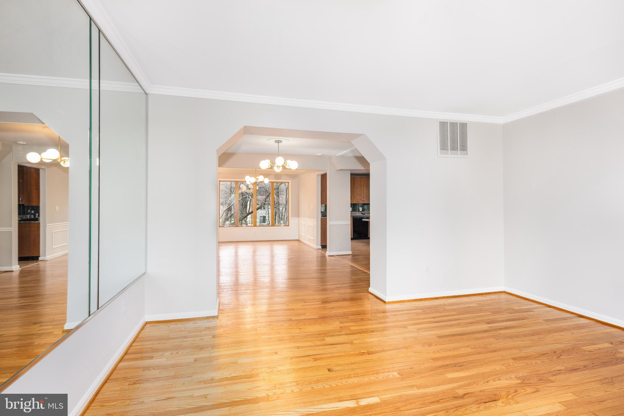 2212 Blue Valley Drive Silver Spring, MD 20904 - Photo 10 of 61 a view of an empty room with wooden floor and a large window