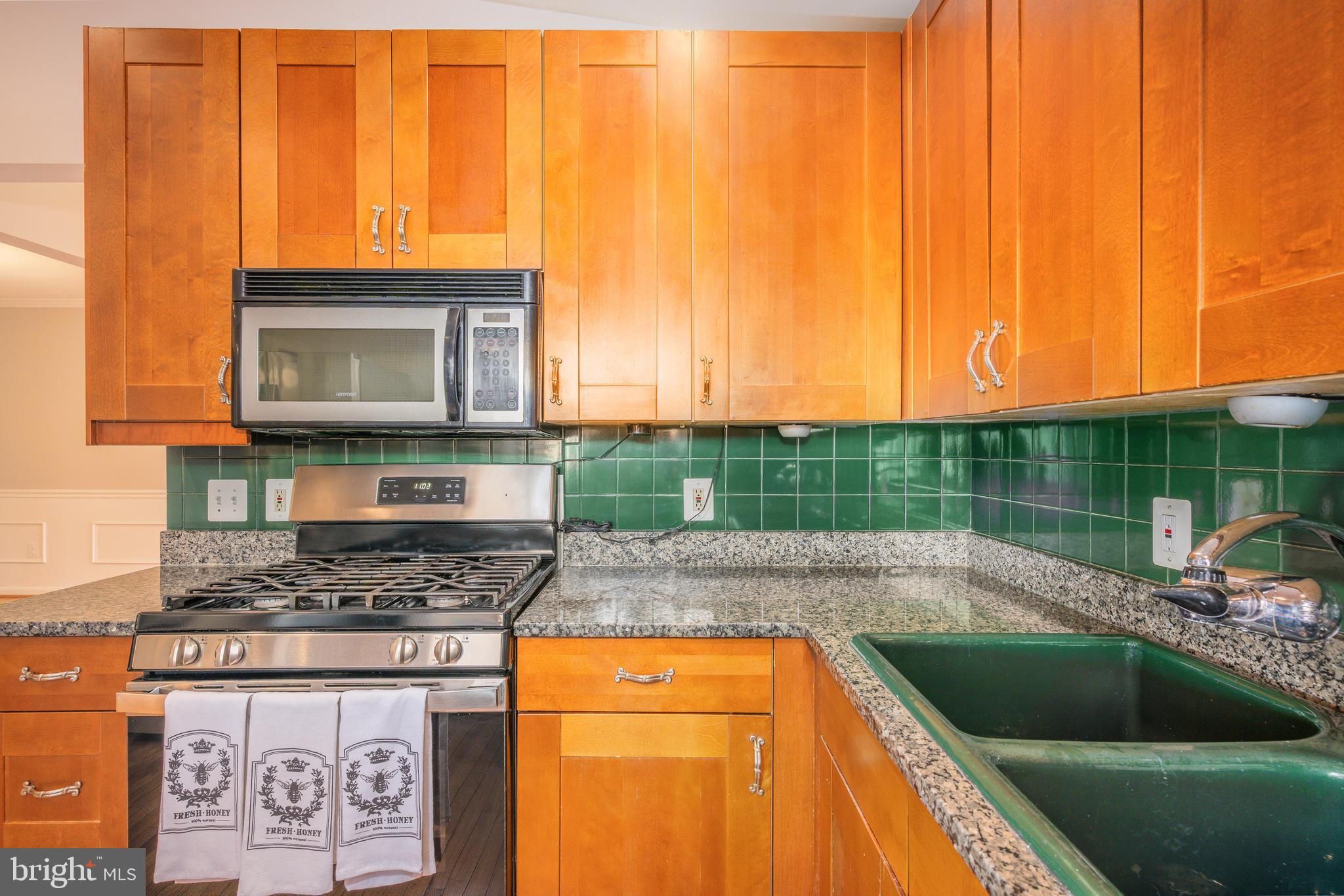 2212 Blue Valley Drive Silver Spring, MD 20904 - Photo 16 of 61 a kitchen with a sink cabinets and a wooden floor