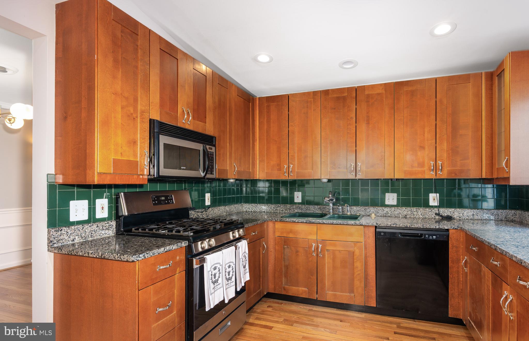 2212 Blue Valley Drive Silver Spring, MD 20904 - Photo 18 of 61 a kitchen with stainless steel appliances granite countertop a stove a sink dishwasher and a microwave oven with cabinets