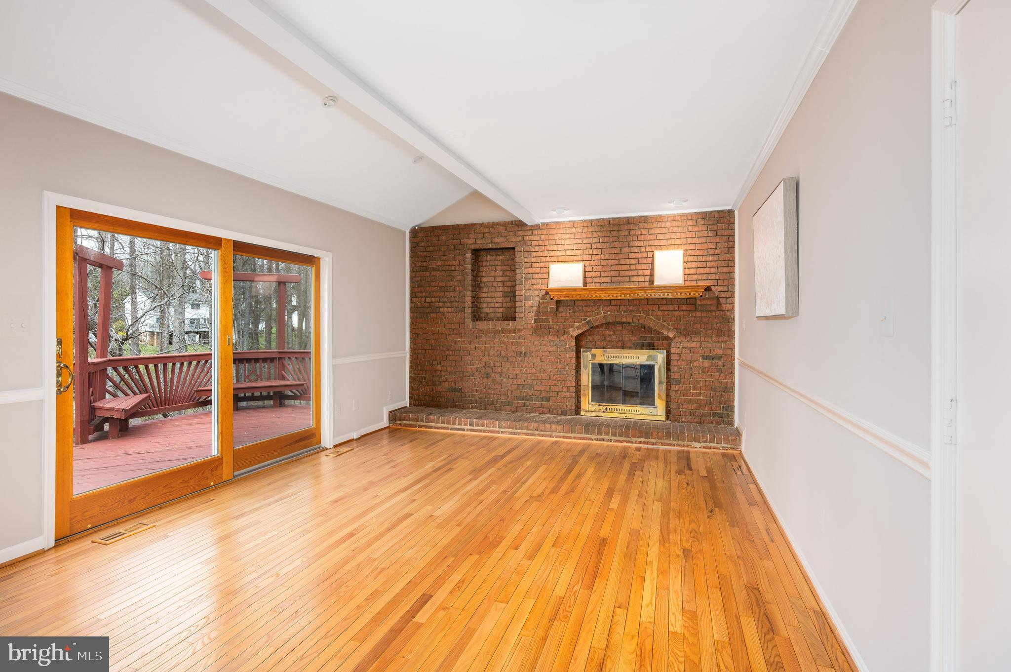 2212 Blue Valley Drive Silver Spring, MD 20904 - Photo 27 of 61 a view of empty room with wooden floor and fireplace