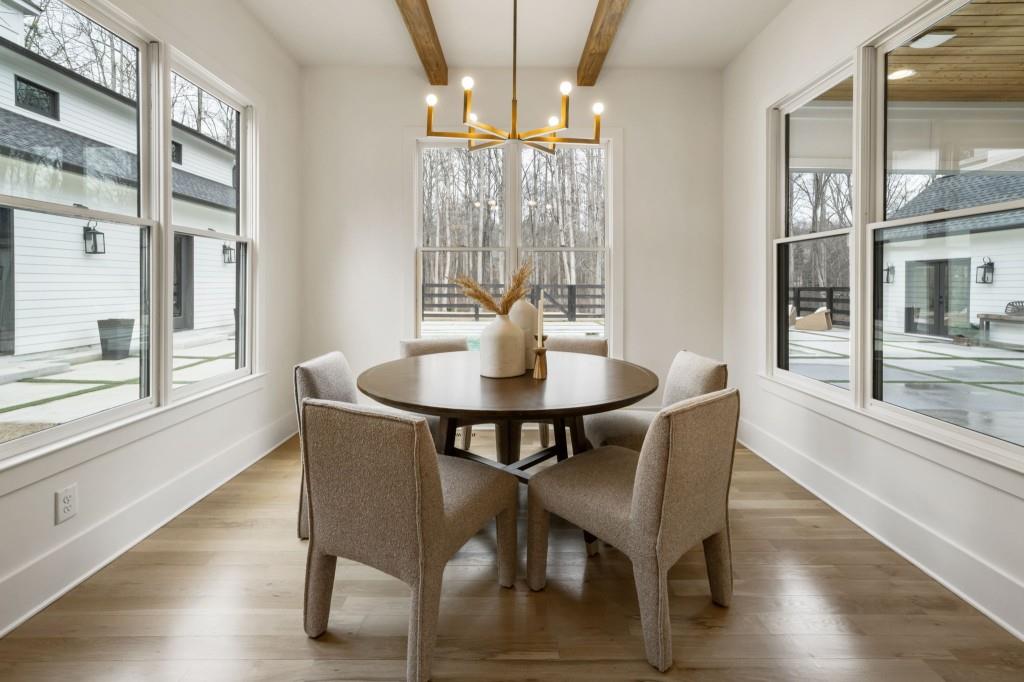 1980 Birmingham Road Milton, GA 30004 - Photo 15 of 78 a dining room with furniture a chandelier and wooden floor
