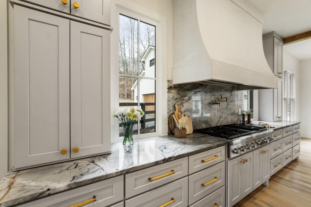 1980 Birmingham Road Milton, GA 30004 - Photo 19 of 78 a kitchen with granite countertop a sink a stove and cabinets