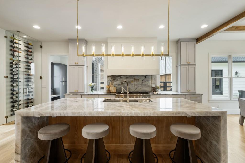 1980 Birmingham Road Milton, GA 30004 - Photo 3 of 78 a kitchen with granite countertop a table chairs stove a sink and living room view