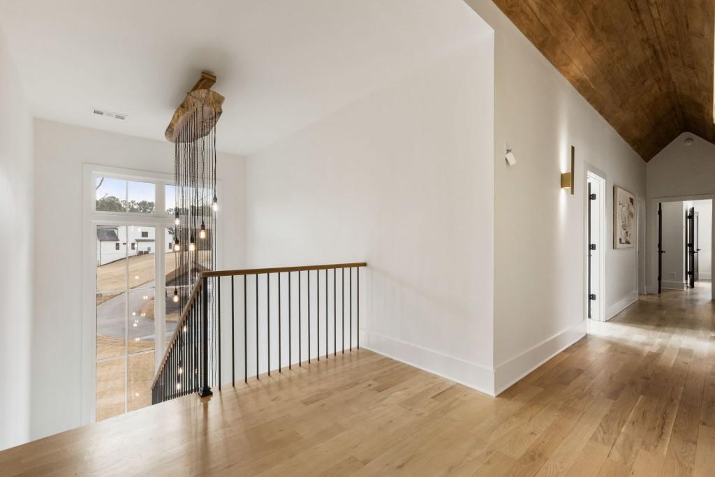1980 Birmingham Road Milton, GA 30004 - Photo 33 of 78 a view of a hallway with wooden floor and staircase