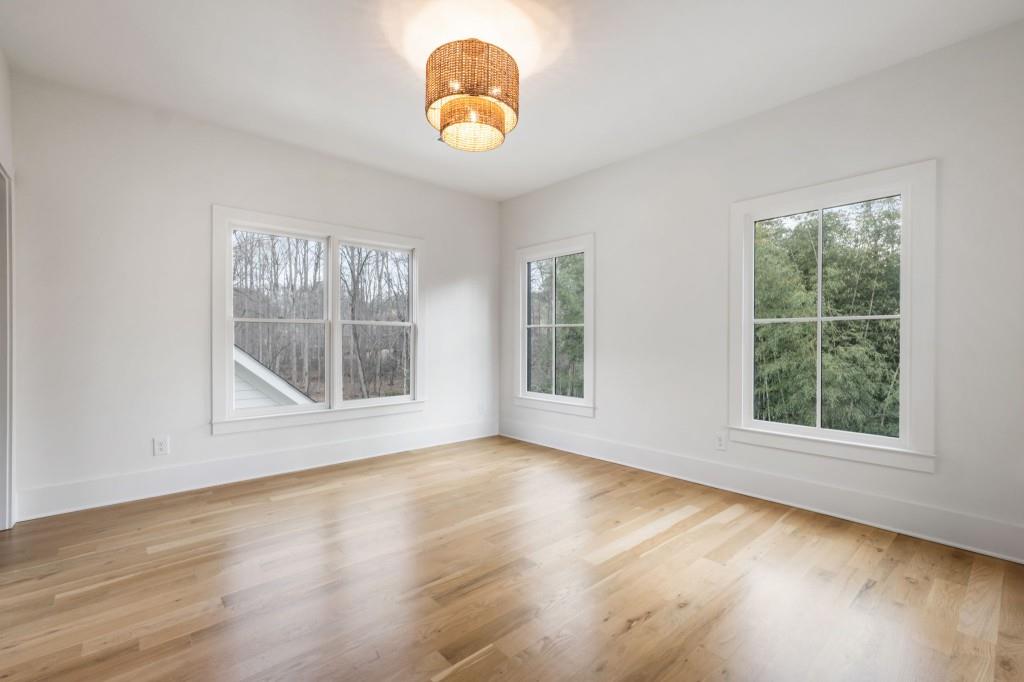 1980 Birmingham Road Milton, GA 30004 - Photo 49 of 78 an empty room with wooden floor and windows