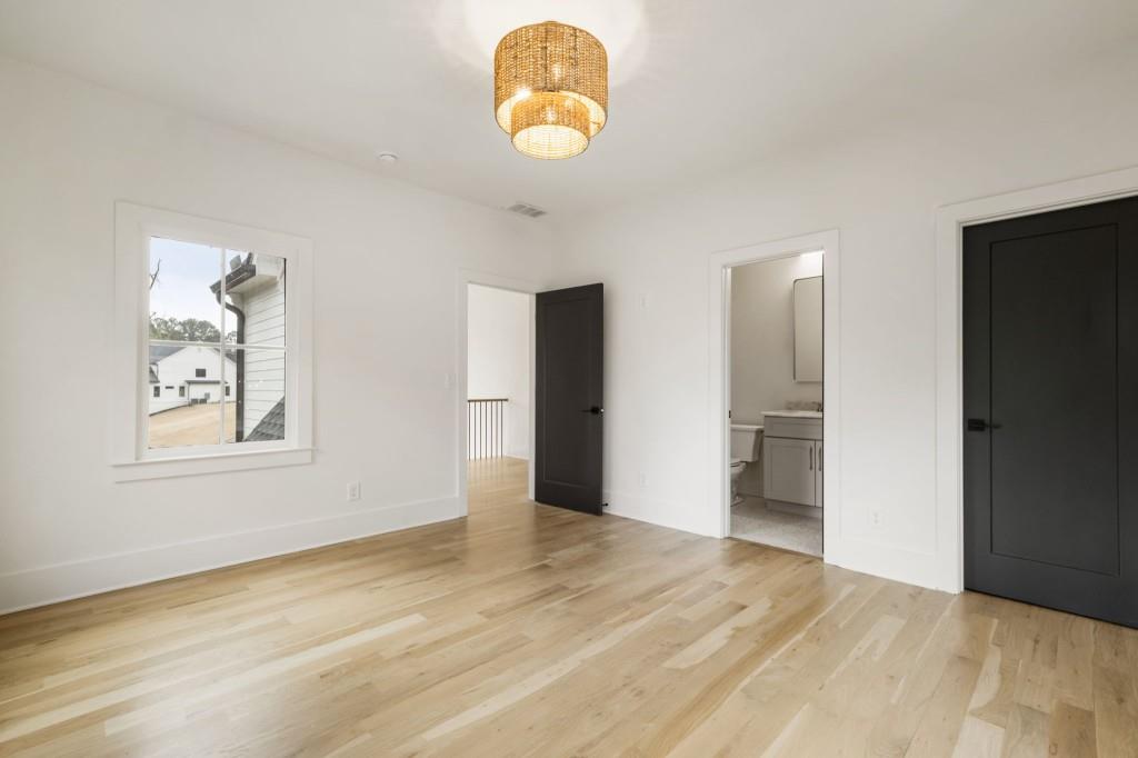 1980 Birmingham Road Milton, GA 30004 - Photo 50 of 78 a view of an empty room with wooden floor and a window