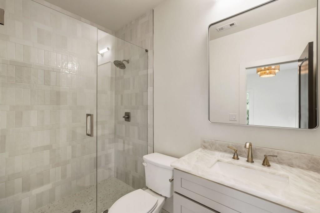 1980 Birmingham Road Milton, GA 30004 - Photo 51 of 78 a bathroom with a granite countertop sink toilet and shower