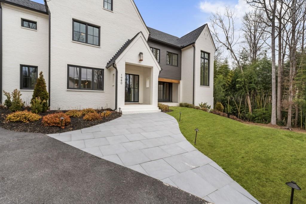 1980 Birmingham Road Milton, GA 30004 - Photo 6 of 78 a front view of a house with a garden and yard