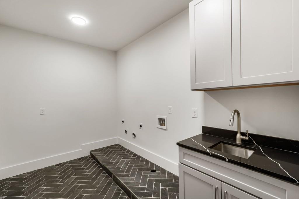 1980 Birmingham Road Milton, GA 30004 - Photo 75 of 78 a kitchen with granite countertop white cabinets and a stove