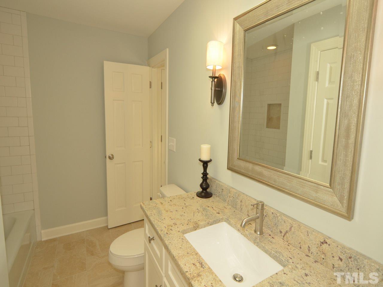 6801 Spring Run Circle Raleigh, NC 27615 - Photo 14 of 23 a bathroom with a granite countertop sink toilet and shower