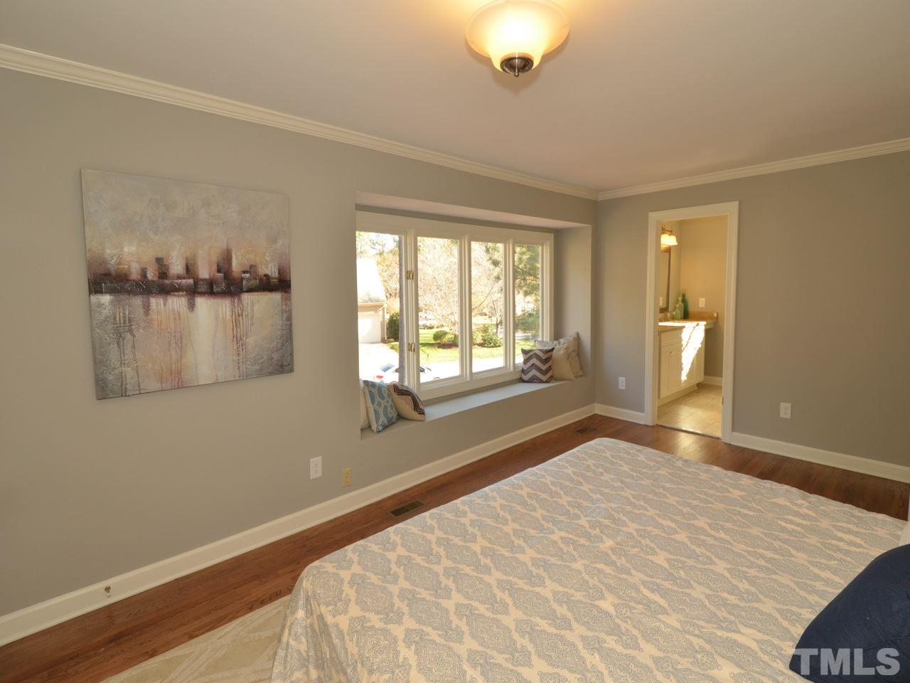 6801 Spring Run Circle Raleigh, NC 27615 - Photo 8 of 23 a view of an empty room with a window and wooden floor