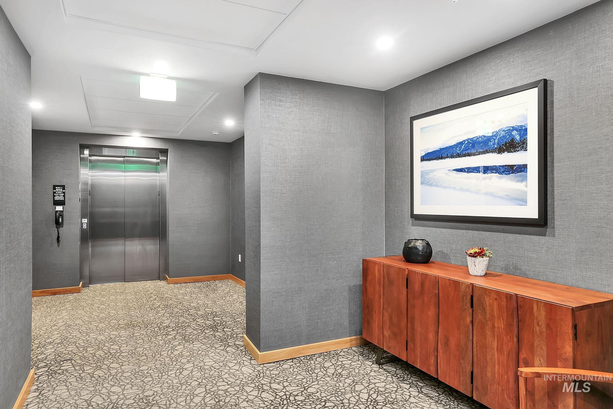 720 Village Drive, Unit 311 Donnelly, ID 83615 - Photo 20 of 37 Corridor featuring elevator and baseboards