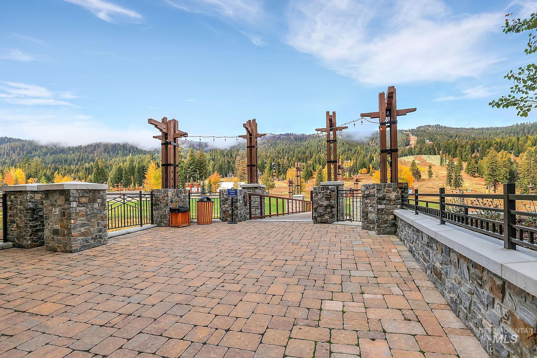 720 Village Drive, Unit 311 Donnelly, ID 83615 - Photo 25 of 37 View of patio with a wooded view and a gate