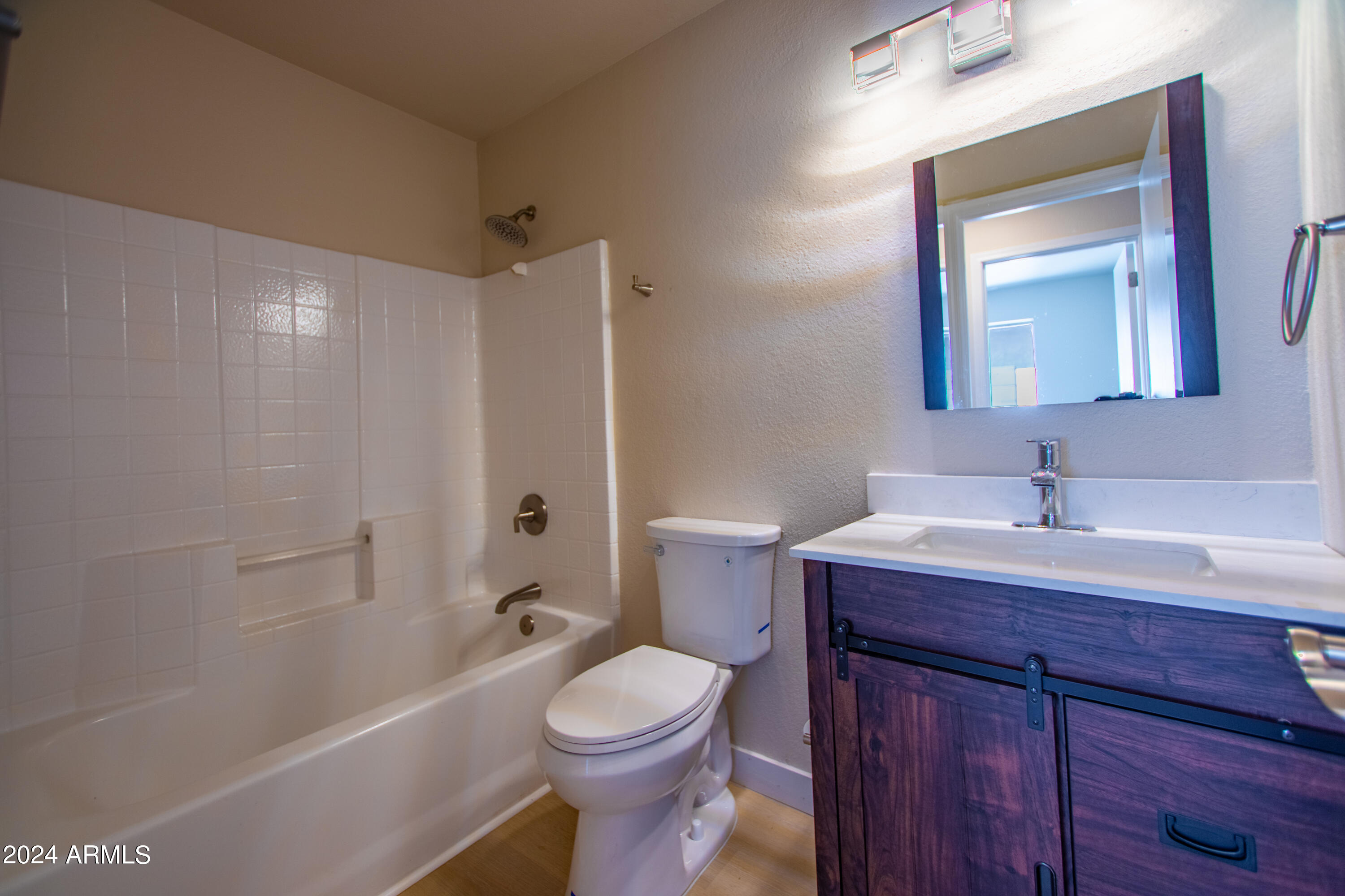 8811 West Coronado Road Phoenix, AZ 85037 - Photo 13 of 23 a bathroom with a sink a toilet and shower
