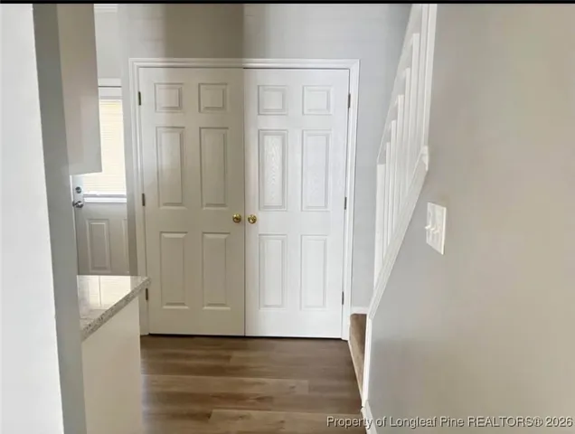 a view of a hallway with wooden floor