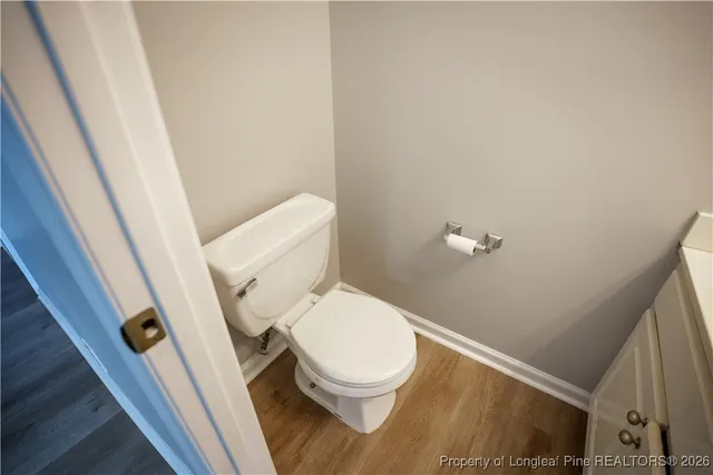 a white toilet sitting next to a sink