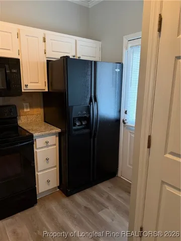 a kitchen with a refrigerator stove and cabinets
