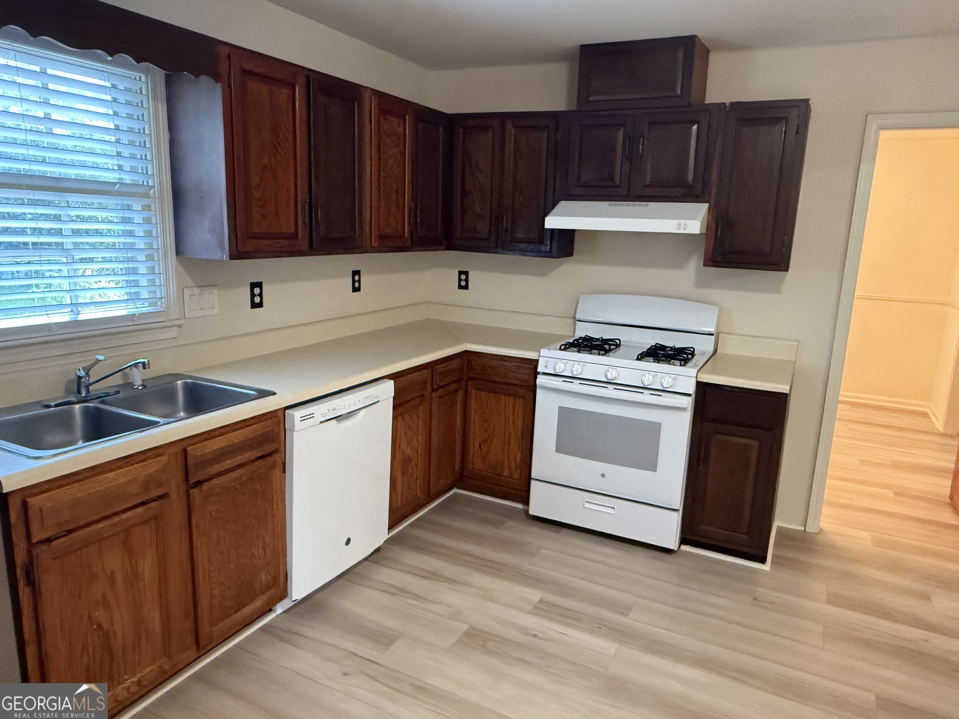 1832 King George Lane Southwest Atlanta, GA 30331 - Photo 11 of 28 a kitchen with wooden cabinets and white appliances