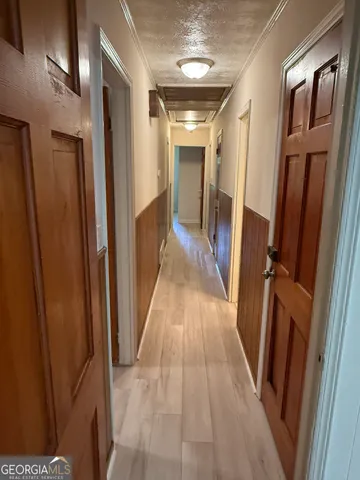 a view of hallway with wooden floor