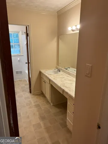 a bathroom with a sink vanity and mirror