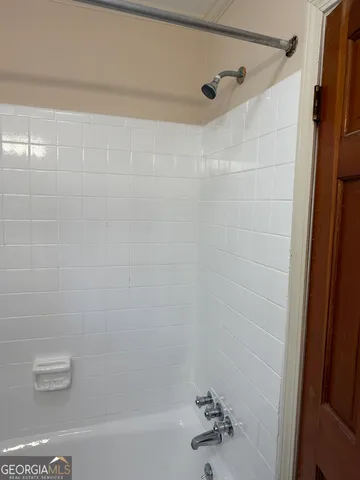 a bathroom with a shower and a bathtub