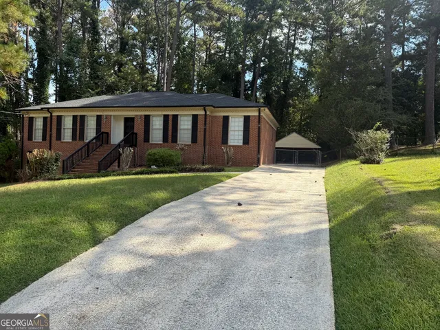 a view of house with yard and green space