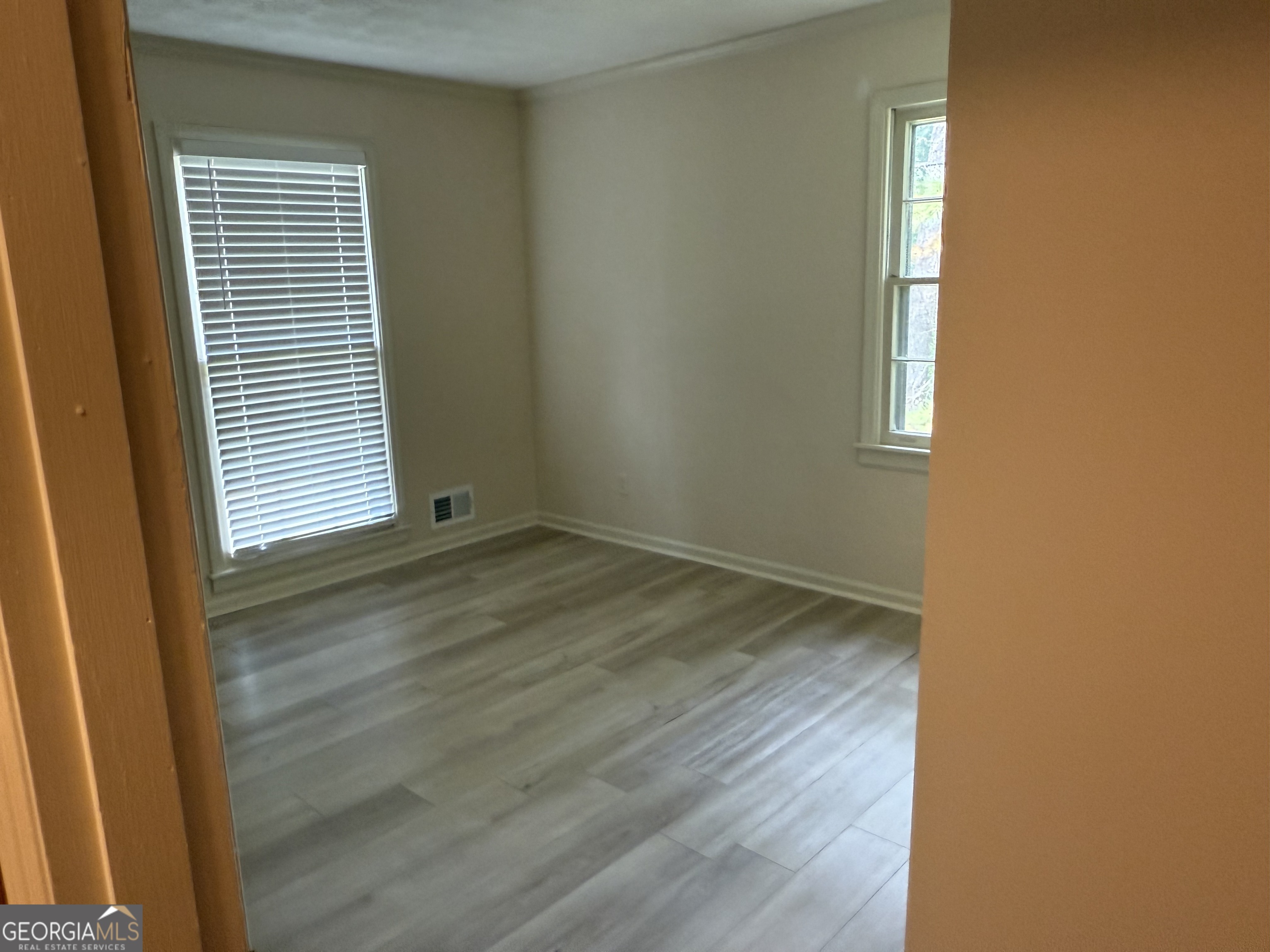 1832 King George Lane Southwest Atlanta, GA 30331 - Photo 22 of 28 a view of an empty room with wooden floor and a window