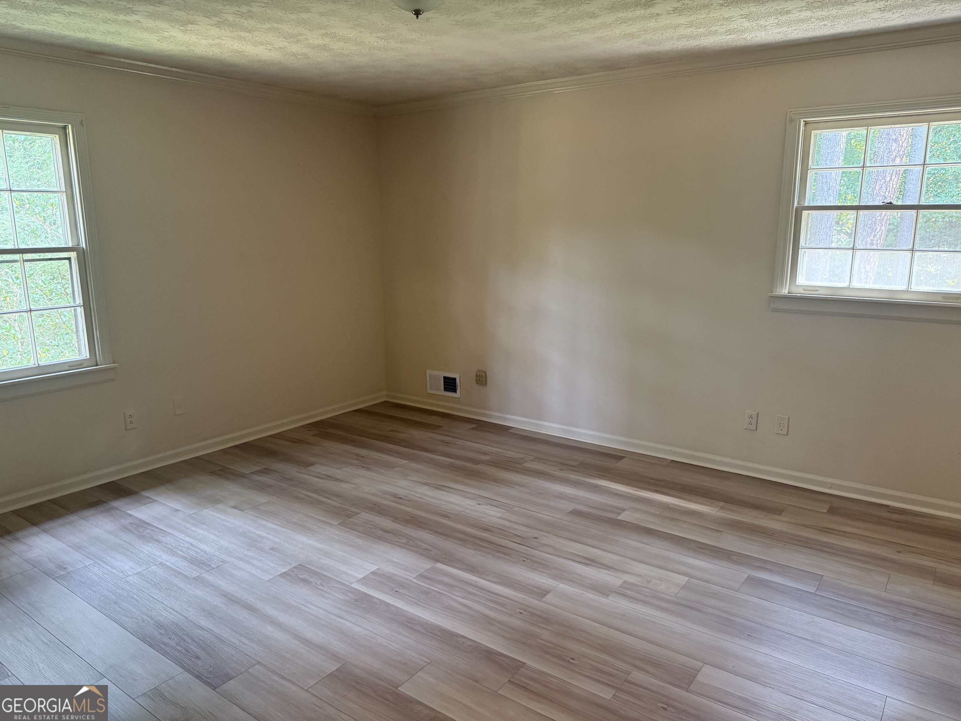 1832 King George Lane Southwest Atlanta, GA 30331 - Photo 24 of 28 an empty room with wooden floor and windows