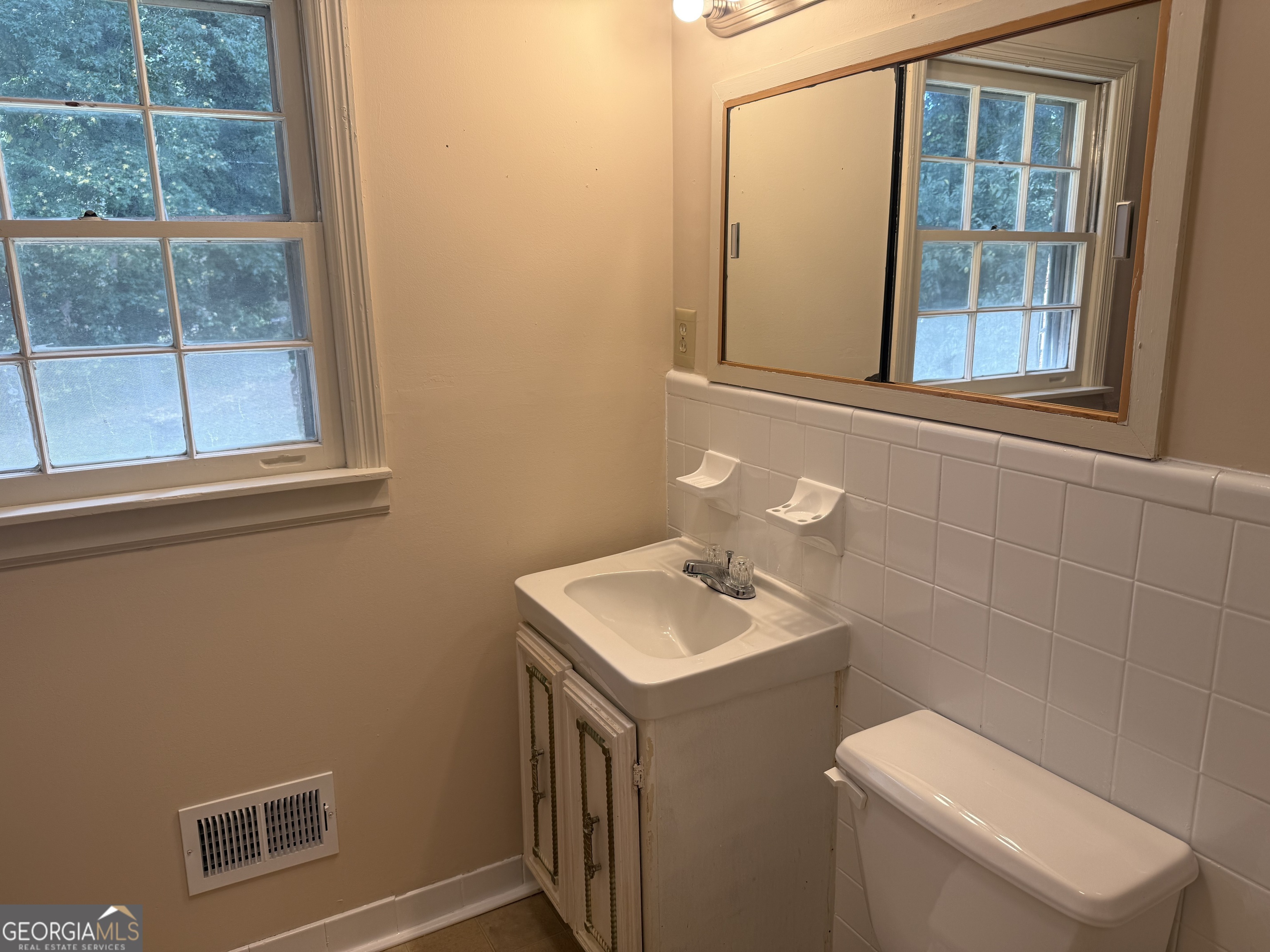 1832 King George Lane Southwest Atlanta, GA 30331 - Photo 28 of 28 a bathroom with a toilet sink and mirror