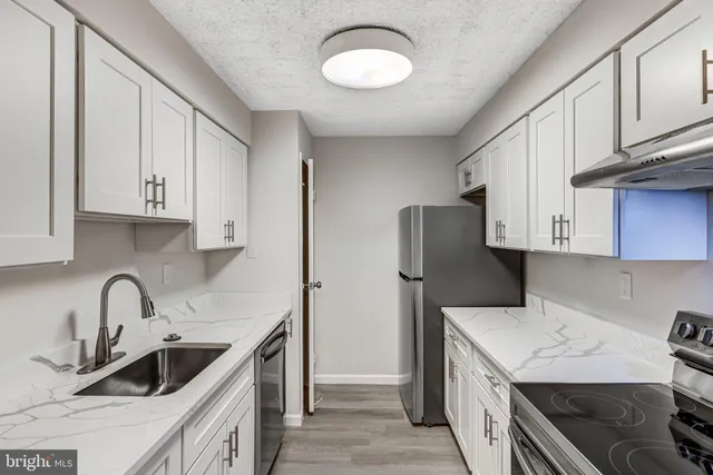 a kitchen that has a sink and a stove in it