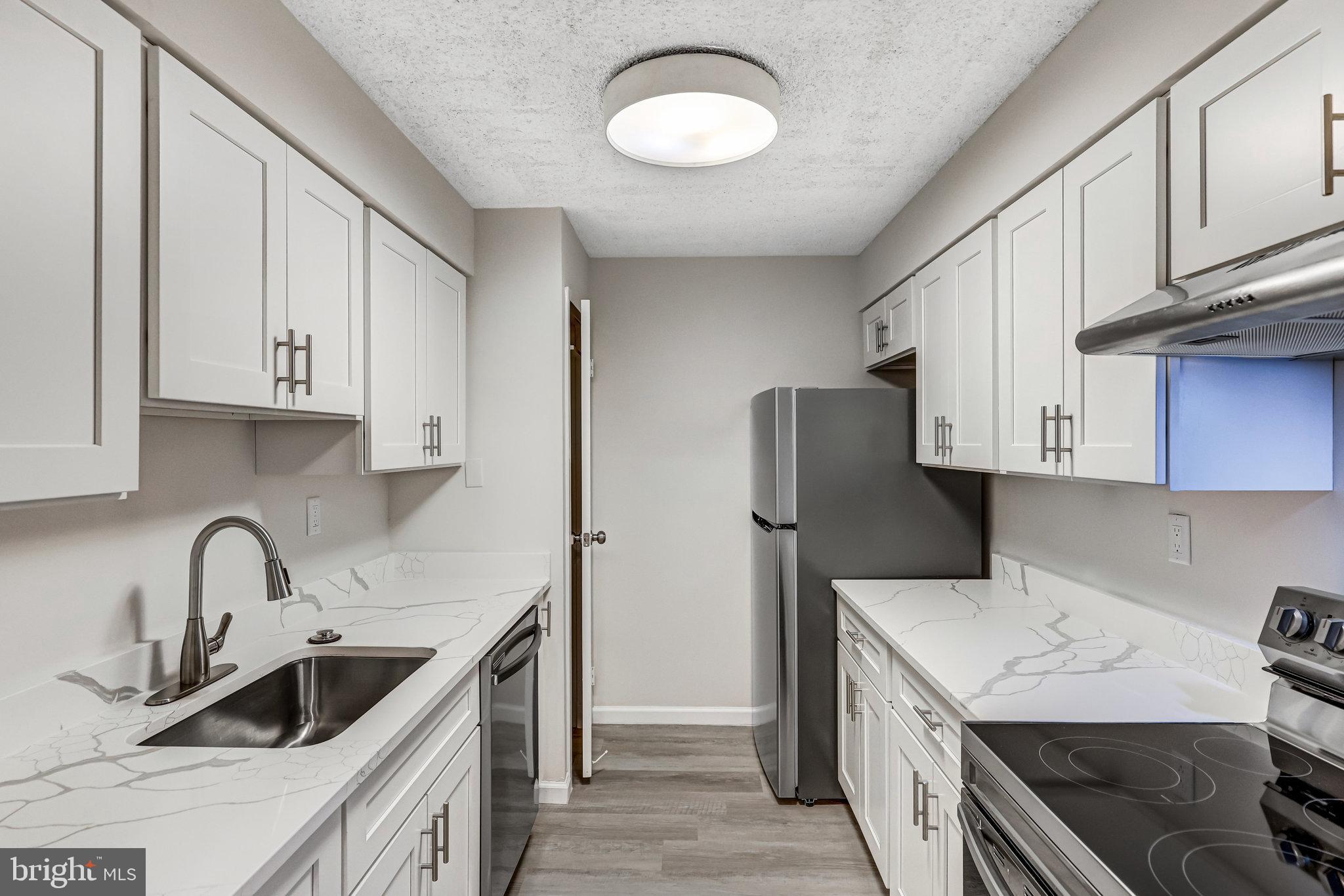 a kitchen that has a sink and a stove in it
