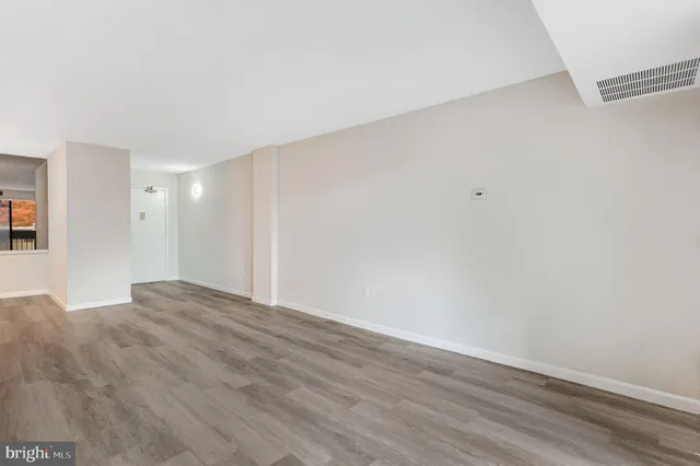 a view of an empty room and wooden floor