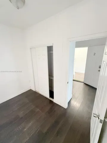 an empty room with wooden floor