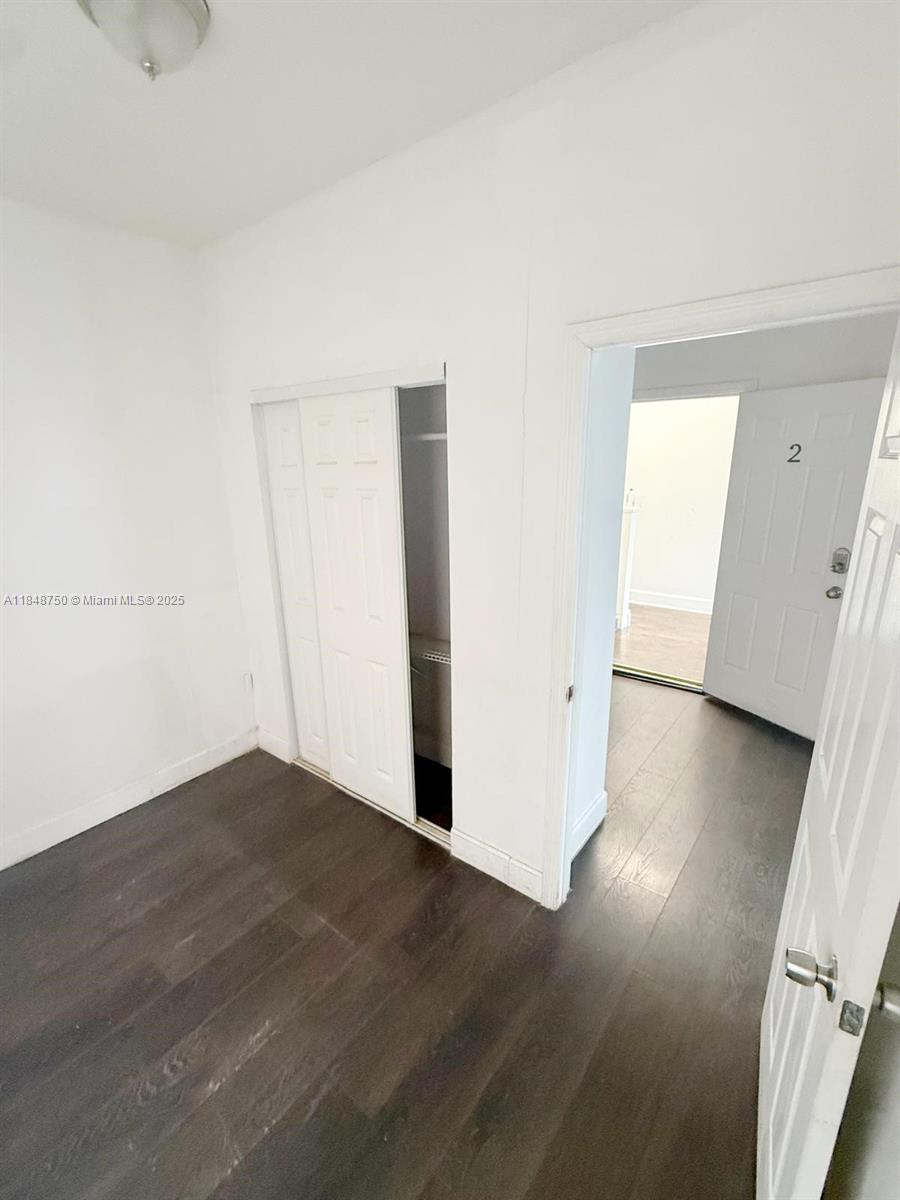 337 Southwest 10th Avenue, Unit 3 Miami, FL 33130 - Photo 6 of 7 an empty room with wooden floor