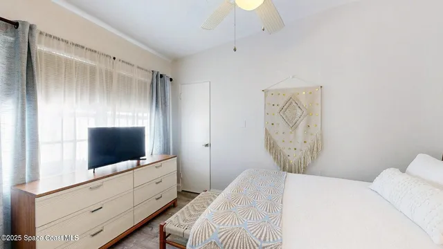 a bedroom with a bed and a flat screen tv