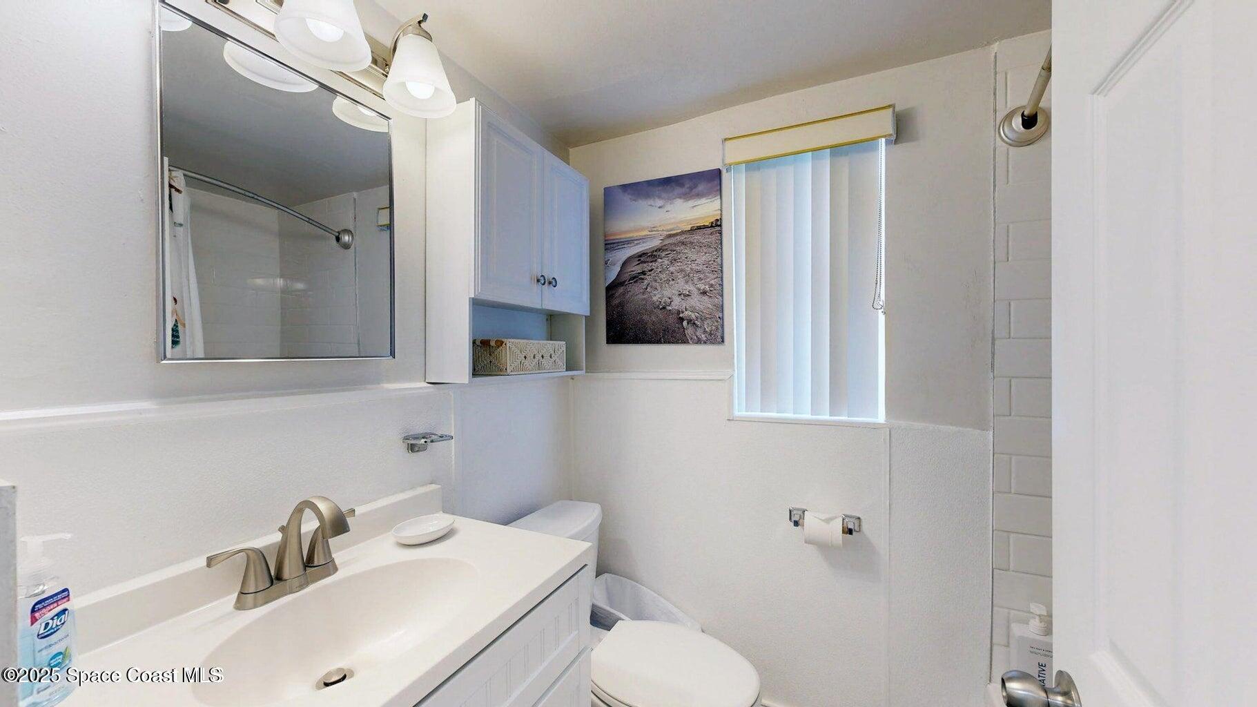 701 South Orlando Avenue, Unit A Cocoa Beach, FL 32931 - Photo 13 of 13 a bathroom with a sink toilet and shower